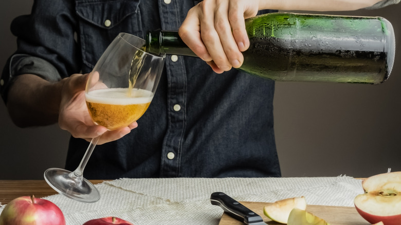 Man pouring hard cider