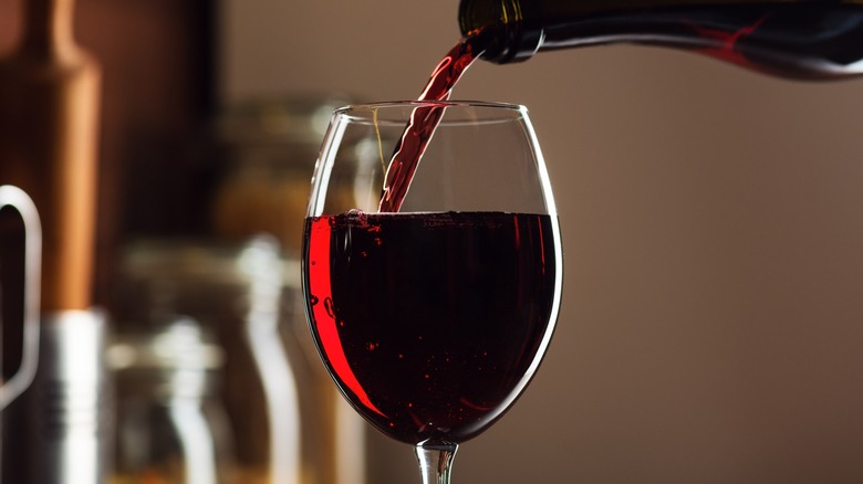 Red wine pouring into a glass