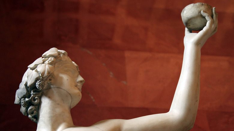 Dionysus statue holding a wine cup