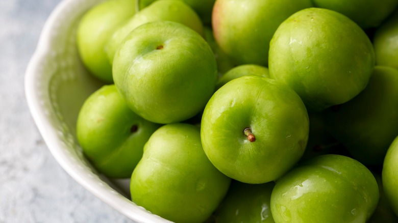 greengage plums in white bowl