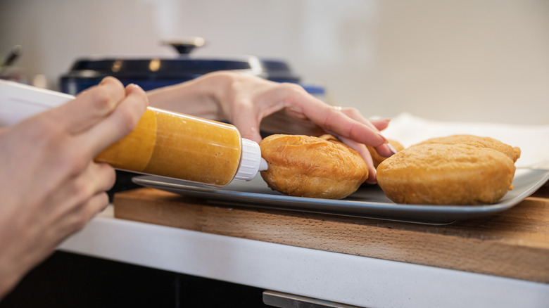 Filling donuts on tray