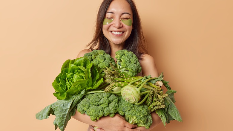 Woman with eye-mask and vegetables