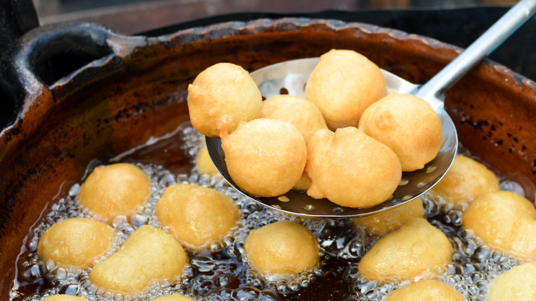 Mexican buñuelos topped with powdered sugar 