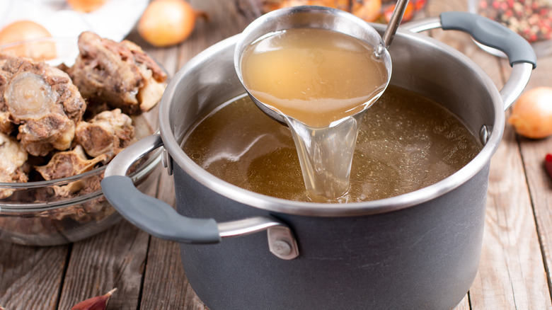 Ladle pouring stock into a pot