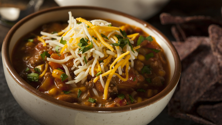 bowl of chili garnished with cheese