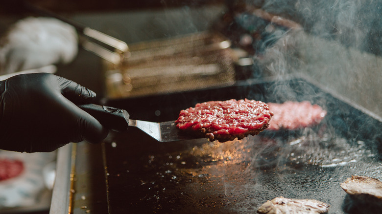 Burger meat on a spatula