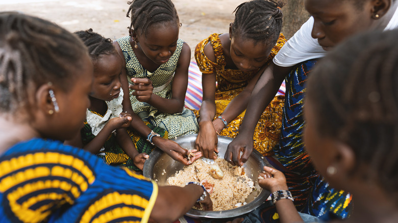 People eating rice with hands