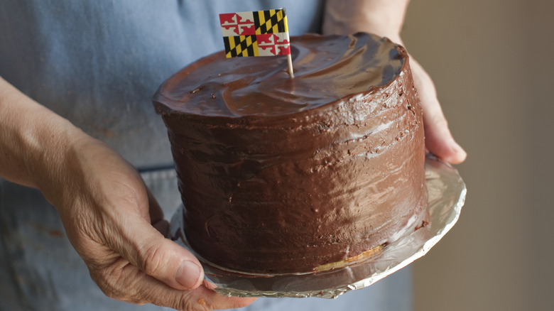 Hands holding a whole Smith Island cake