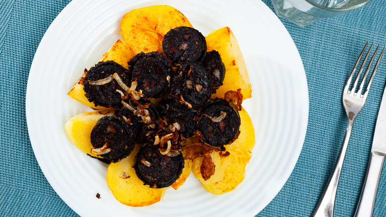 Spanish blood sausage served over potatoes