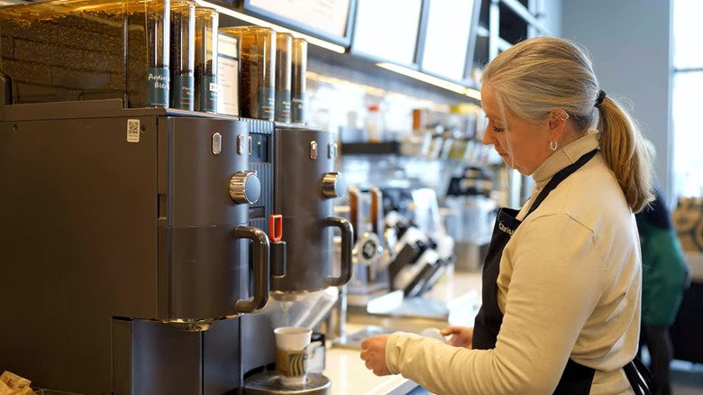 Barista brewing coffee with a Clover Vertica machine