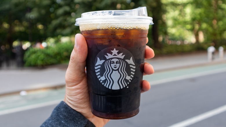 Hand holding Starbucks iced coffee