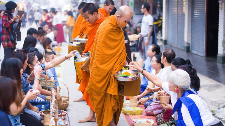 offering sticky rice to monks