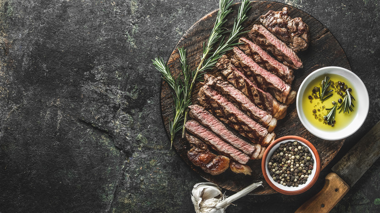 Strip steak on cutting board