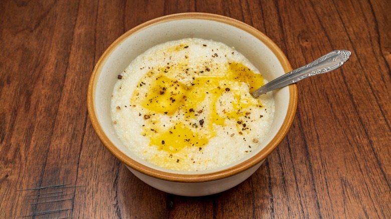 bowl of grits with butter, pepper