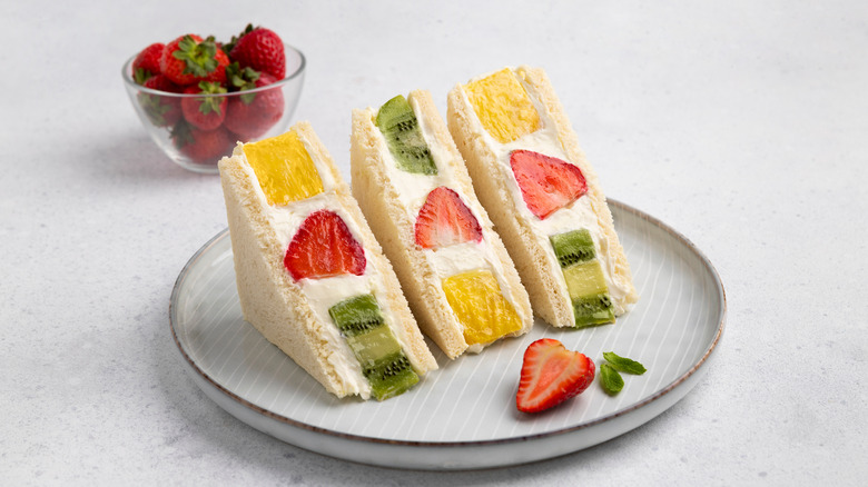 Three sandwiches with fruit