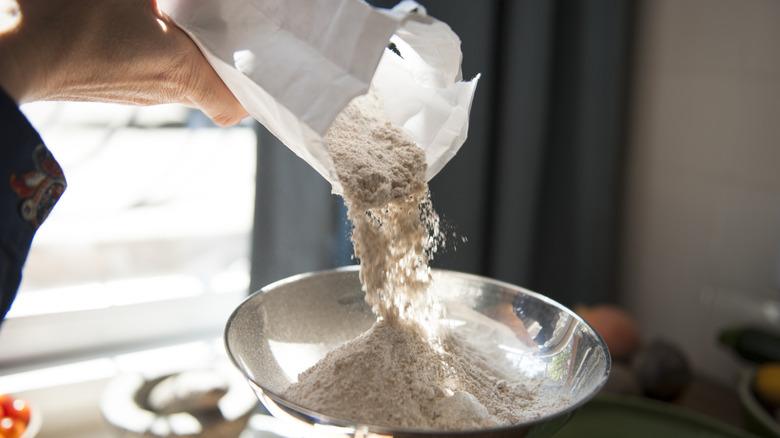 pouring flour into a bowl