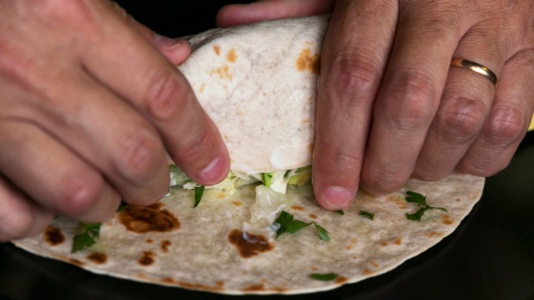 Hands making a burrito