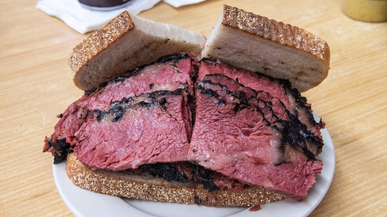 sliced black pastrami sandwich