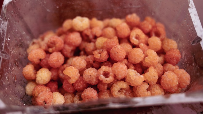 plastic carton of golden raspberries