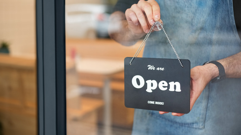 Black sign reading "open"