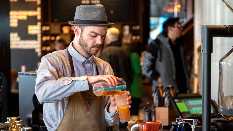 Starbucks employee in tan apron