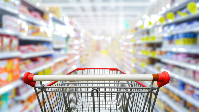 empty cart in grocery aisle