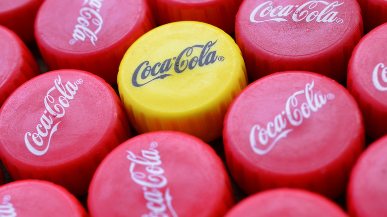 coca-cola caps with one yellow cap