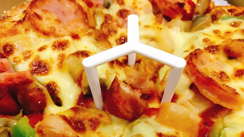 close up of a pizza saver on a pizza