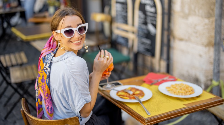 Woman eating dinner outside