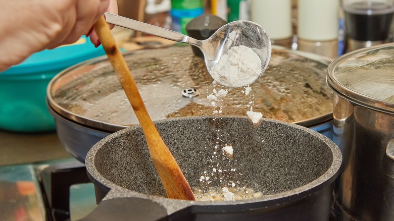 Adding flour into sauce