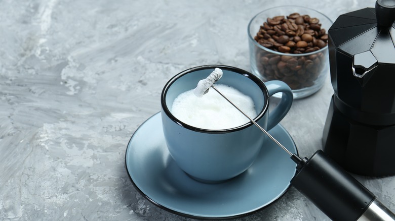 frothed milk in blue mug