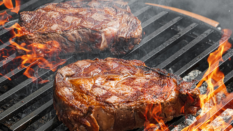 Steaks being cooked on a grill