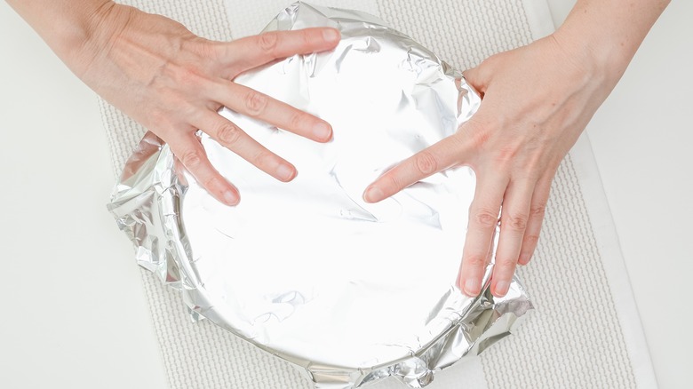 covering cake pan in foil