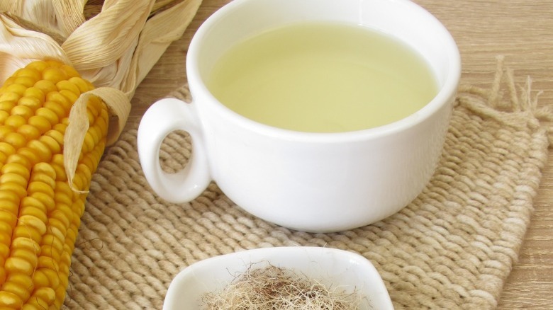 Corn silk tea in a mug with corn 