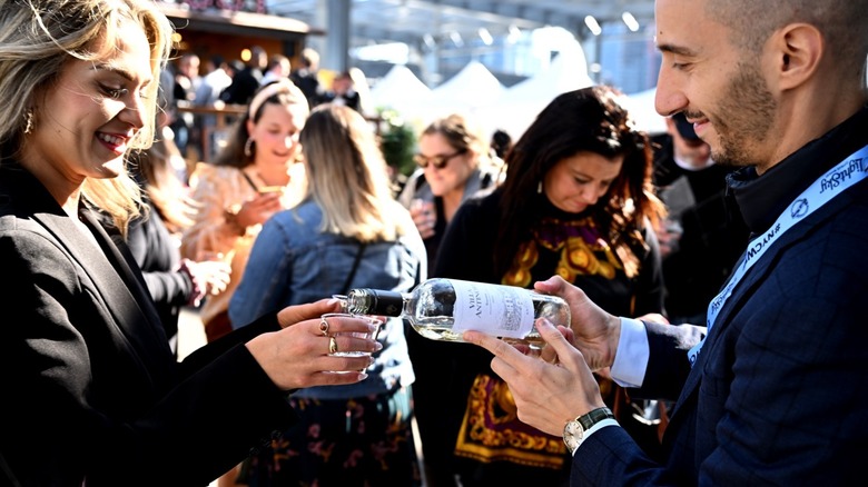 Festival attendees pouring drink