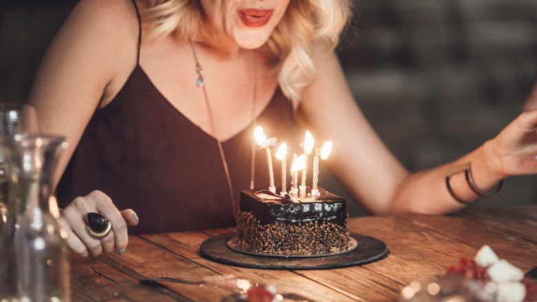 Birthday cake in front of pink background 