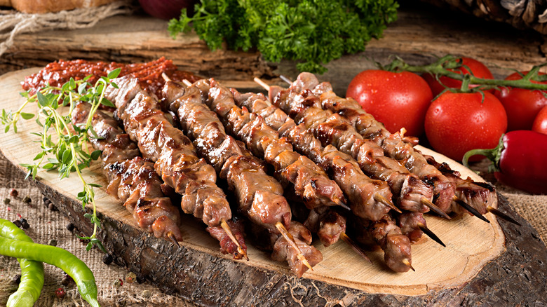 Lamb skewers by tomatoes