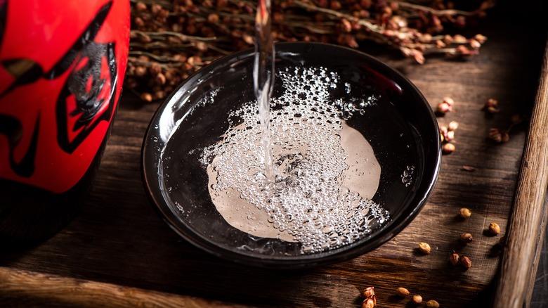 Clear liquor being poured into a bowl