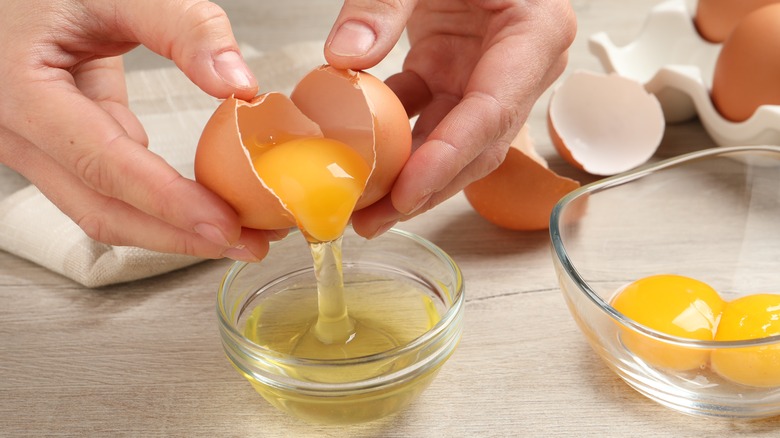 Hand separating egg