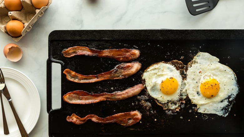 frying breakfast food on griddle