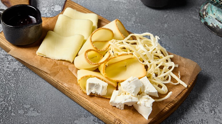 assortment of cheeses on board