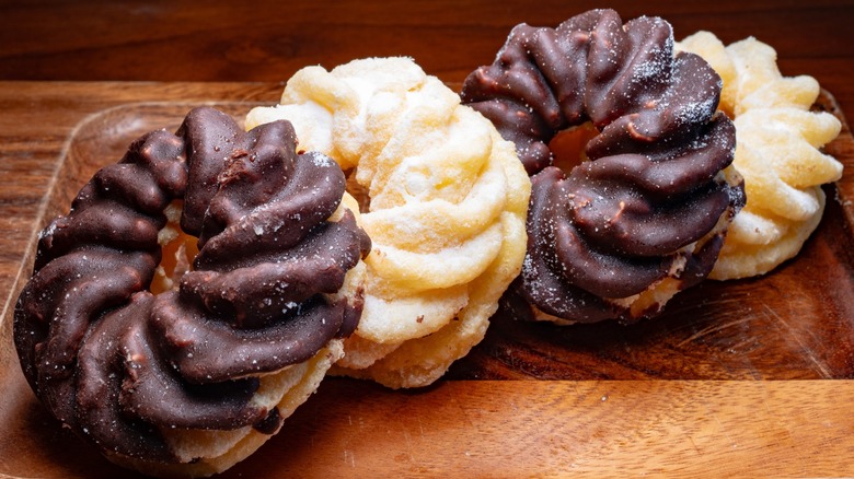 Four French crullers on a plate