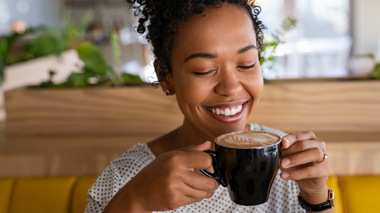 woman enjoys cup of coffee 