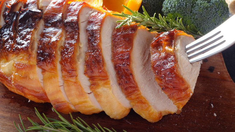 Sliced turkey breast speared fork