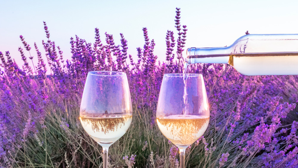 rosé wine poured in two glasses with backdrop of lavender