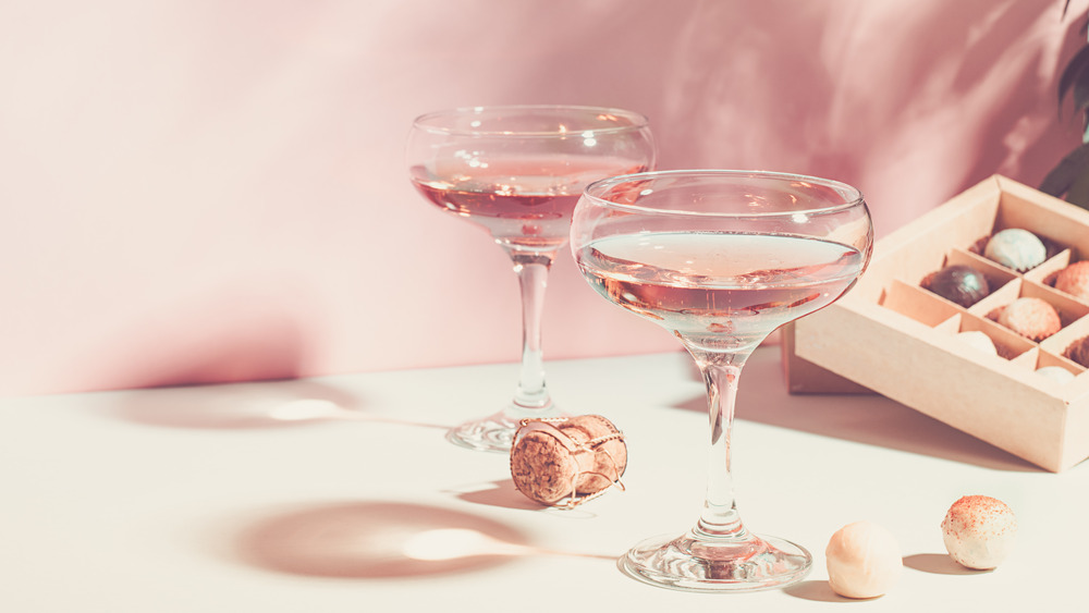 pink champagne in glasses with corks