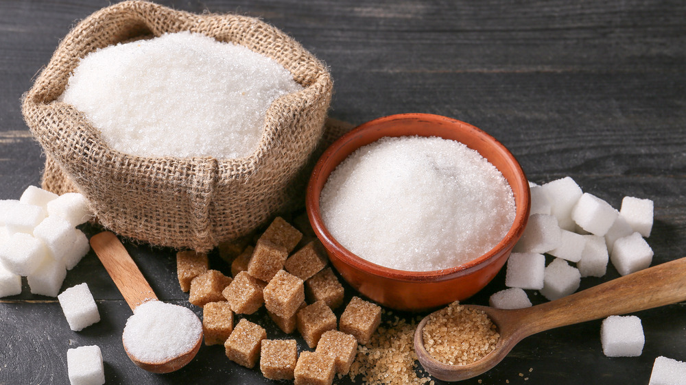 different kinds of sugar on a wooden surface