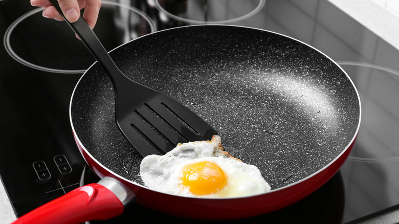 frying egg with nylon spatula