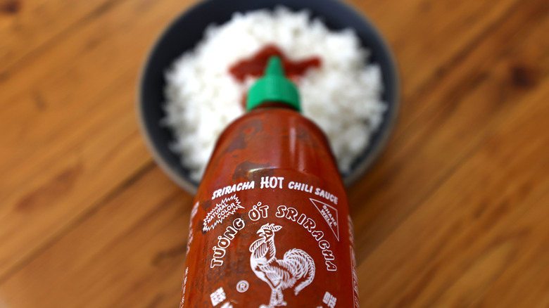 Sriracha bottle over rice 