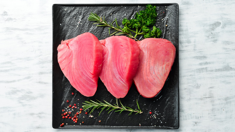 raw tuna steaks on plate